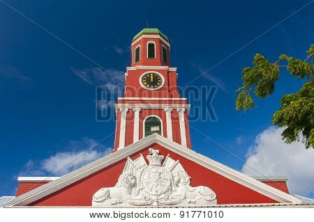 Famous red clock tower on the main guardhouse at the Garrison Savannah. UNESCO garrison historic area Bridgetown, Barbados