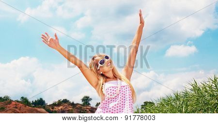 Pretty Young Woman With Arms Raised