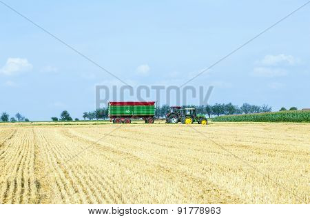Farmer With Tractor At The Field