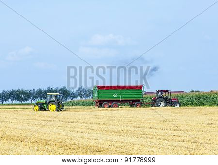 Farmer With Tractor At The Field