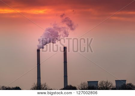 Industrial cityscape with coal power plant and smoke stacks
