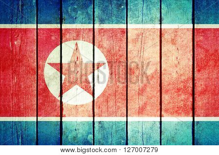 North Korea wooden grunge flag. North Korea flag painted on the old wooden planks. Vintage retro picture from my collection of flags.