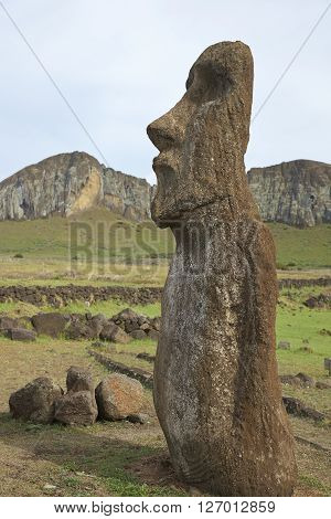 Ahu Tongariki. Ancient Moai statue on the coast of Rapa Nui (Easter Island). In the background is Rano Raraku, from where the statues were carved.