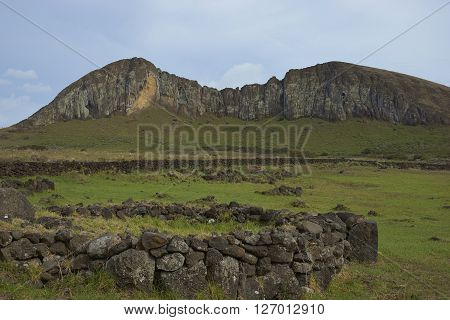 Ahu Tongariki. Site of a large group of ancient Moai statue on the coast of Rapa Nui (Easter Island). In the background is Rano Raraku, from where the statues were carved.