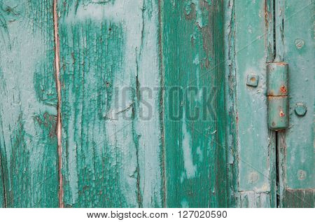 Grunge old wood panels ruined by weather with hinge