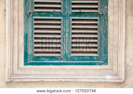 Green window made with weathered wood panels