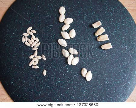 seeds of three types of vegetable cultures against a dark background