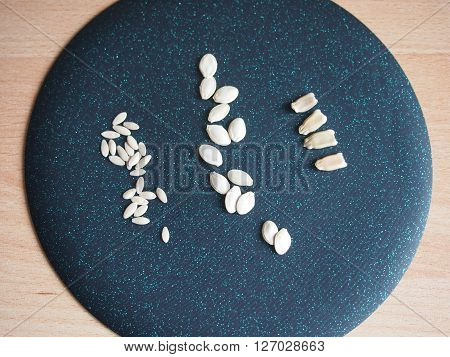 seeds of three types of vegetable cultures against a dark background