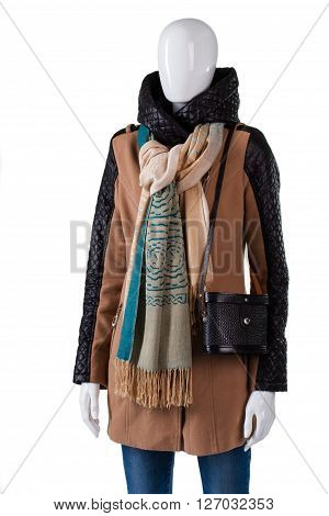 Scarf with jacket and purse. Female mannequin wearing trendy scarf. Dark handbag with brown garment. Brand new outerwear in stock.