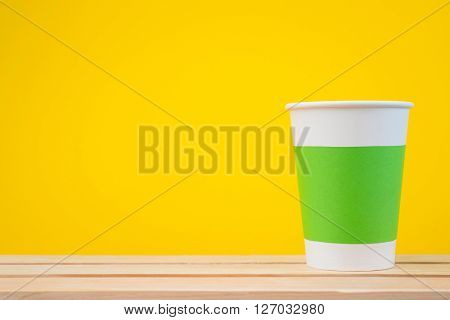 Paper cup with Sleeve on yellow background