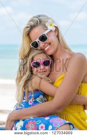 Cute Girl And Beautiful Mother On The Beach