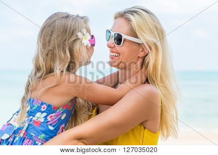 Cute Girl And Beautiful Mother On The Beach