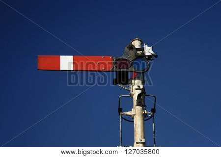 Railway transport track signal in stop position, Norfolk UK.