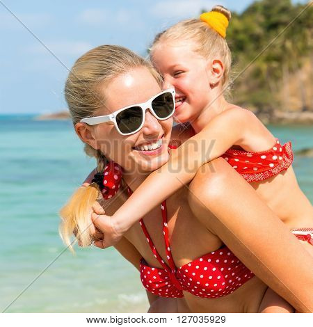 Cute Girl And Beautiful Mother On The Beach