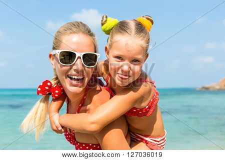 Cute Girl And Beautiful Mother On The Beach