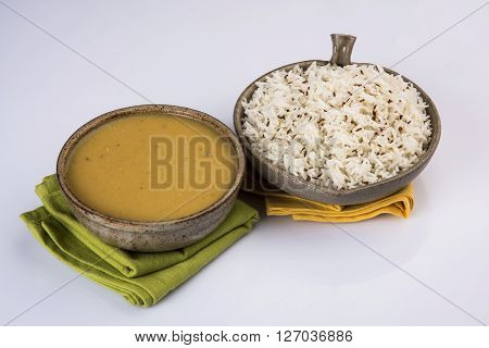 Whole Yellow Lentil with Rice, dal tadka and jeera rice, Indian Dish, cooked rice and cooked Arhar or Toor dal (Pigeon Pea), served in ceramic bowl