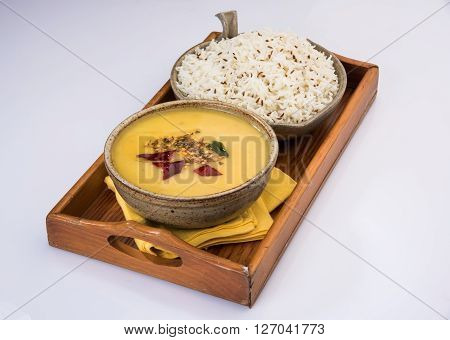 Whole Yellow Lentil with Rice, dal tadka and jeera rice, Indian Dish, cooked rice and cooked Arhar or Toor dal (Pigeon Pea), served in ceramic bowl