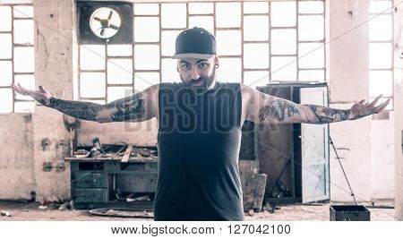 Portrait of the tattooed man with open hands