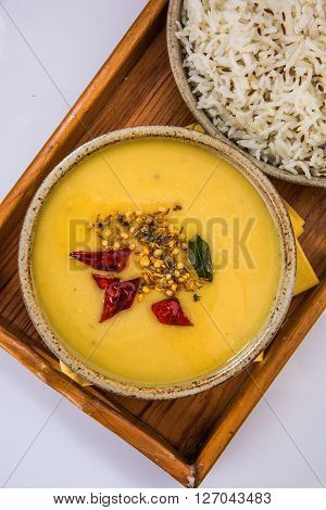 Whole Yellow Lentil with Rice, dal tadka and jeera rice, Indian Dish, cooked rice and cooked Arhar or Toor dal (Pigeon Pea), served in ceramic bowl