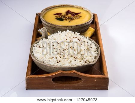 Whole Yellow Lentil with Rice, dal tadka and jeera rice, Indian Dish, cooked rice and cooked Arhar or Toor dal (Pigeon Pea), served in ceramic bowl
