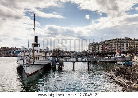 GENEVA, SWITZERLAND - APRIL 11, 2015: Exterior views of the buildings and fountain at the Geneva Lake on April 11 2015. Its the second most populous city in Switzerland (after Zurich).