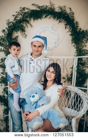 Beautiful family with baby boy waiting for Christmas