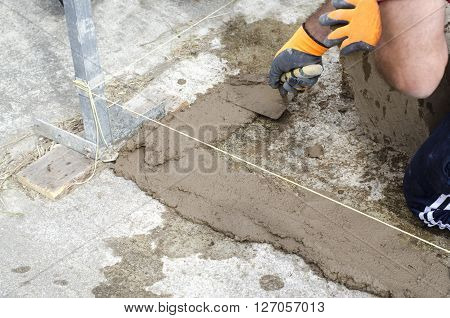 Bricklayer Working With Mud Bricks For Building A Wall.