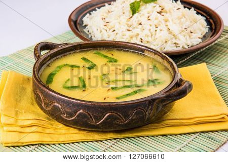 Whole Yellow Lentil with Rice, dal tadka and jeera rice, Indian Dish, cooked rice and cooked Arhar or Toor dal (Pigeon Pea), served in ceramic bowl