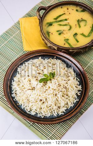 Whole Yellow Lentil with Rice, dal tadka and jeera rice, Indian Dish, cooked rice and cooked Arhar or Toor dal (Pigeon Pea), served in ceramic bowl