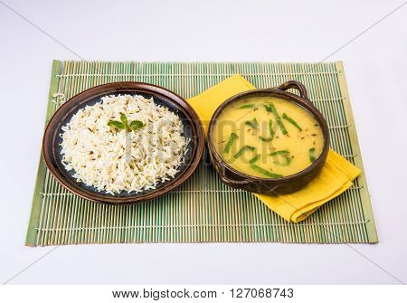 Whole Yellow Lentil with Rice, dal tadka and jeera rice, Indian Dish, cooked rice and cooked Arhar or Toor dal (Pigeon Pea), served in ceramic bowl
