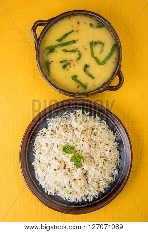 Whole Yellow Lentil with Rice, dal tadka and jeera rice, Indian Dish, cooked rice and cooked Arhar or Toor dal (Pigeon Pea), served in ceramic bowl