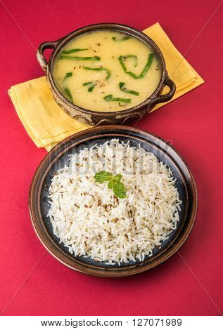 Whole Yellow Lentil with Rice, dal tadka and jeera rice, Indian Dish, cooked rice and cooked Arhar or Toor dal (Pigeon Pea), served in ceramic bowl
