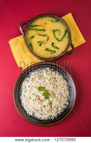 Whole Yellow Lentil with Rice, dal tadka and jeera rice, Indian Dish, cooked rice and cooked Arhar or Toor dal (Pigeon Pea), served in ceramic bowl