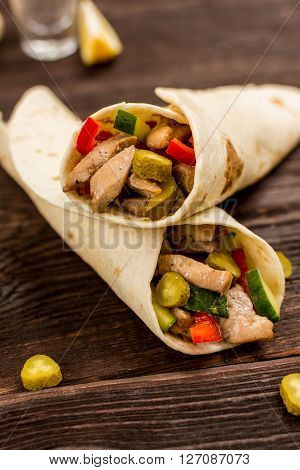 Traditional mexican tortila wrap with meat and vegetables