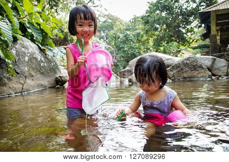 Asian Little Chinese Girls Playing In Creek