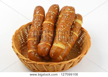 scuttle of fresh bread rolls on white background - close up