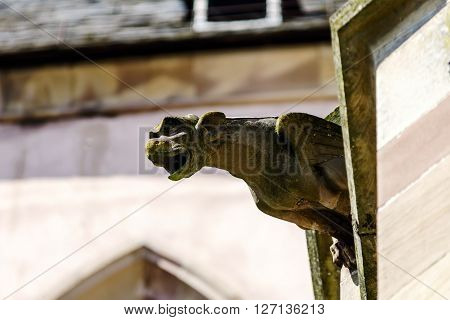 Gargoyle On A Gothic Cathedral, Detail Of A Tower On Blue Sky Background