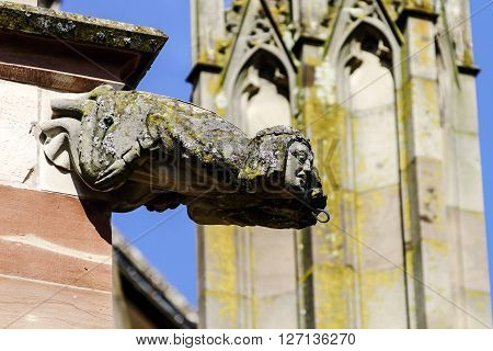 Gargoyle On A Gothic Cathedral, Detail Of A Tower On Blue Sky Background