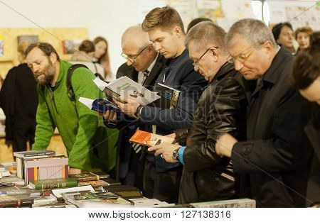 KYIV, UKRAINE - APR 21, 2016: Many different age serious men reading books of the 6th International Festival BOOK ARSENAL on April 21, 2016. Guests of the fair were Lars Svendsen Vigdis Hjorth Etgar Keret