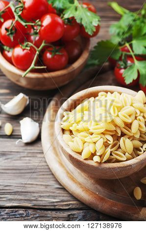 Sardinian raw pasta malloreddus with tomato selective focus