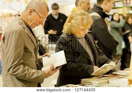 KYIV UKRAINE - APR 21, 2016: Many visitors of the 6th International Festival BOOK ARSENAL holding books in bookstore on April 21, 2016. Guests of fair were writers Lars Svendsen Vigdis Hjorth Etgar Keret