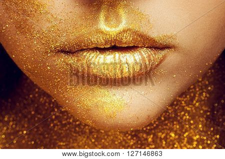 Magic Girl Portrait in Gold. Golden Makeup close-up portrait in studio shot color