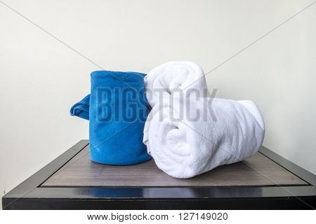 white towels on wood table in bathroon