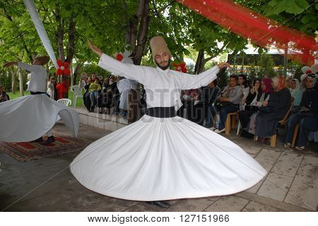ANKARA/TURKEY-MAY 8, 2015: Sufi whirling dervish (Semazen) dances at the garden of YEKAD Association's cultural event. May 8, 2015-Ankara/Turkey
