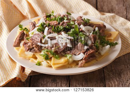 Beshbarmak Dish: Noodles With Lamb And Onion Close-up On A Plate. Horizontal