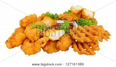 Group of fried battered chicken nugget bites and lattice fries with tomato dipping sauce isolated on a white background