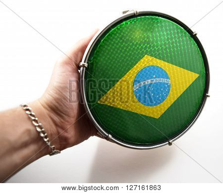Green Brazilian drum called "tamborim" with Brazil flag on it.  Used in Carnaval celebrations in Rio de Janeiro, Salvador, and other cities.  Text on drum: "Order and Progress."  Isolated.