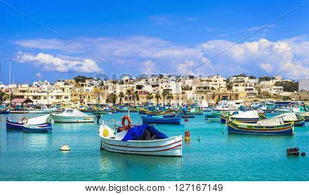 Marsaxlokk village with traditional colorful fishing boats Luzzu