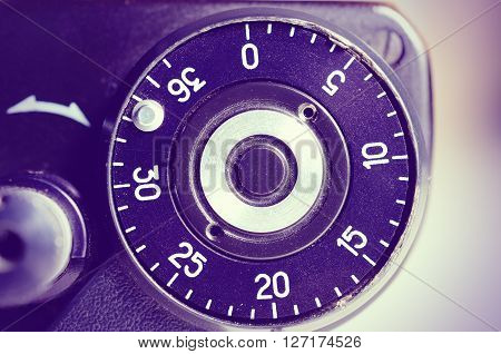 Fragment of old film camera. Top view of shutter button and the frame counter. Close up view. Macro. Selective focu. sVintage photo. Toning.
