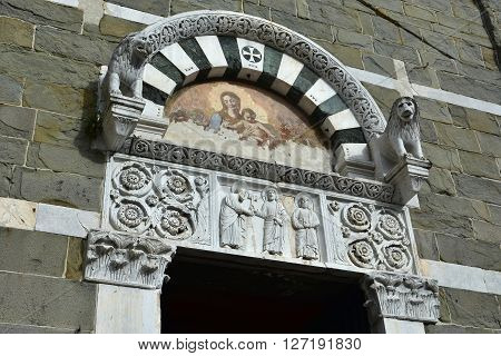 Beautiful medieval portal of San Pietro Somaldi church with lions as guardian and ancient fresco